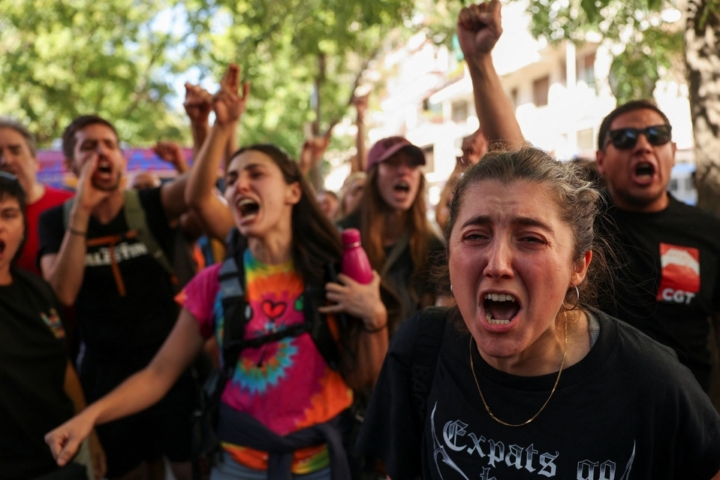 Housing activists react, after Maricarmen Abascal, 87, was taken away on a stretcher to an ambulance, in Madrid, September 23. REUTERS/Susana Vera
