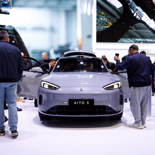 Visitors inspect a Huawei Aito M5 at the 2024 Paris Auto Show in Paris, France, October 15, 2024. REUTERS/Benoit Tessier/File Photo