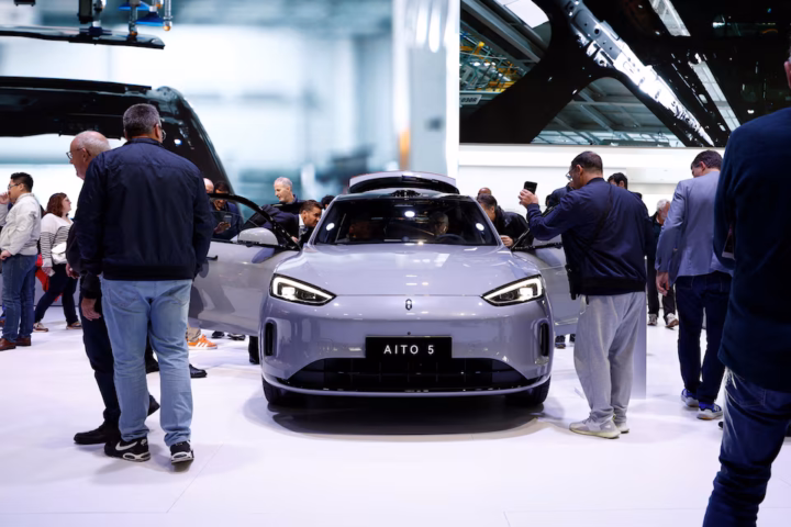 Visitors inspect a Huawei Aito M5 at the 2024 Paris Auto Show in Paris, France, October 15, 2024. REUTERS/Benoit Tessier/File Photo