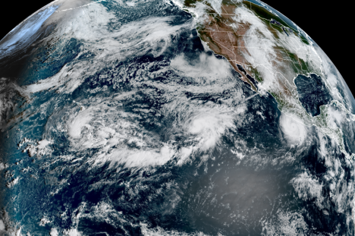 Three tropical systems were active in the central and eastern Pacific Ocean on Wednesday. Tropical Depression 15E was south of Hawaii, Hurricane Polo was near Mexico and Hurricane Odalys was between the two in the open ocean. (CSU/CIRA & NOAA)