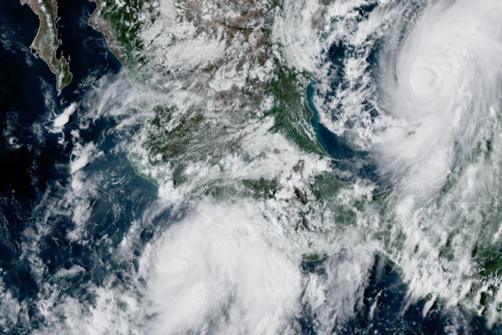 This GOES-19 GeoColor satellite image provided by the National Oceanic and Atmospheric Administration (NOAA) and taken at 4:57 p.m. EDT, Wednesday, Oct. 7, 2026, shows Tropical Storm Simon, bottom center, in the Pacific Ocean, off the southwestern coast of Mexico, and Tropical Storm Isaias, upper right, east of Mexico in the Gulf of Mexico. (NOAA via AP)