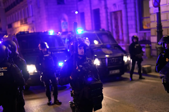 Police officers cordon off the area as protesters gather after the reported death of María del Carmen Abascal, the 87-year-old woman whose eviction sparked nationwide protests, outside Parliament in Madrid, Wednesday, Oct. 7, 2026. (AP Photo/Bernat Armangue)